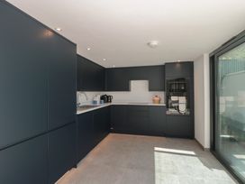 A kitchen with cabinets and appliances at Number 7 in Bishop Sutton