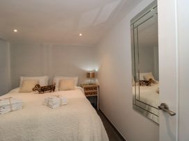 A bedroom with a bed, pillows and towels at Number 7 in Bishop Sutton