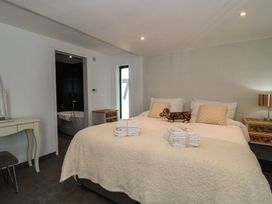 A bedroom with a bed and towels at Number 7 in Bishop Sutton