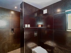 A bathroom with a toilet and shelves at Number 7 Bishop Sutton