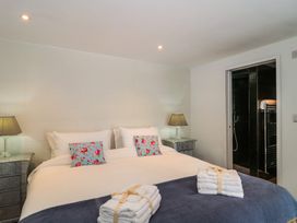 A bedroom with a bed and lamps at Number 7 in Bishop Sutton