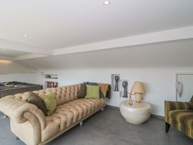 A snug with a sofa and pool table at Number 7 in Bishop Sutton