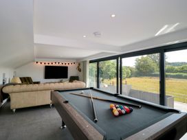A game room with a pool table and sofa at Number 7 in Bishop Sutton
