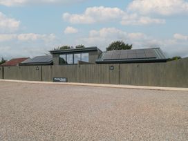 An exterior view of Whatley House with solar panels at Whatley House in Bishop Sutton