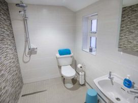 A bathroom with a toilet a sink a shower area and a window at 1 Willow Cottage in Upton Upon Severn