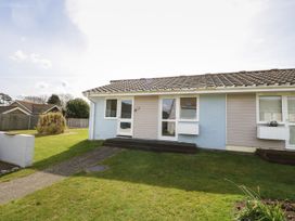 A semi detached bungalow with front doors and windows surrounded by grass at Pierpont D1 Norton near Yarmouth