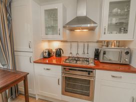 A kitchen with a gas stove oven microwave kettle toaster and utensils at Pierpont D1 in Norton near Yarmouth