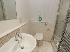 A small bathroom with a sink toilet shower and a towel radiator at Pierpont D1 in Norton near Yarmouth
