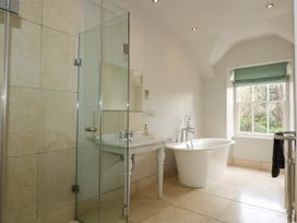 A bathroom with a freestanding bathtub sink shower and a window with a green blind at Tan Llan in Llanelltyd near Dolgellau