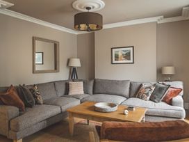A living room with a grey sofa and coffee table at Tan Llan in Llanelltyd near Dolgellau