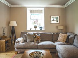 A living room with a sofa and coffee table at Tan Llan in Llanelltyd near Dolgellau