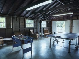 A game room with a foosball table and ping pong table at Tan Llan in Llanelltyd near Dolgellau