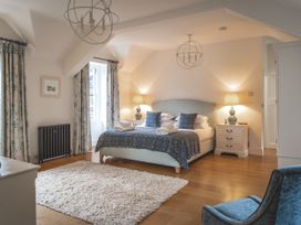 A bedroom with a bed and nightstands at Tan Llan in Llanelltyd near Dolgellau