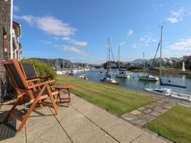 A view of sailing boats on water with deck chairs at 1 Oakley Wharf Porthmadog