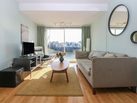 A living room with a coffee table and sofa at 1 Oakley Wharf in Porthmadog