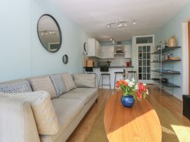 A living room with a sofa and coffee table at 1 Oakley Wharf in Porthmadog