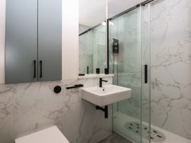 A bathroom with a sink and shower at 1 Oakley Wharf Porthmadog