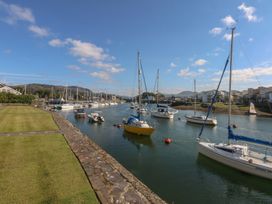 A marina with boats along a channel at 1 Oakley Wharf Porthmadog