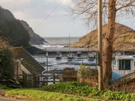A view of boats on a shore with hills and the sea in the background at Cove View in Ilfracombe