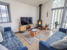 A living room with a television and fireplace at Fig Tree Lodge Hutton Roof near Penrith