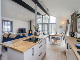 An open plan living area with a kitchen and dining table at Fig Tree Lodge near Hutton Roof near Penrith