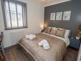 A bedroom with a bed and bedside table at Fig Tree Lodge Hutton Roof near Penrith
