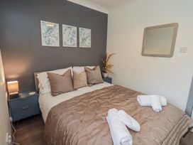 A bedroom with a bed and nightstand at Fig Tree Lodge near Penrith