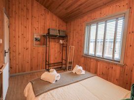 A bedroom with bed and towels at Fig Tree Lodge Hutton Roof near Penrith
