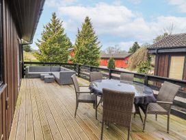 A patio with seating arrangements at Fig Tree Lodge Hutton Roof near Penrith