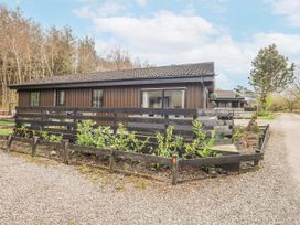 A house with a fence and plants in front at Fig Tree Lodge in Hutton Roof near Penrith