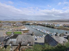 A harbor with boats docked near houses and a marina at Captain's Rest in Porthmadog