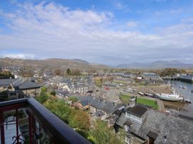 A town view with boats on water and hills in the background at Captain's Rest in Porthmadog