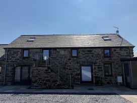 A building with stairs and windows at 3 Trem y Mor Llanfwrog near Llanfachraeth