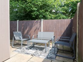 An outdoor patio with seating and a table at Hub House Three Oaks near Hastings