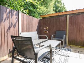 An outdoor patio with seating and a table at Hub House in Three Oaks near Hastings