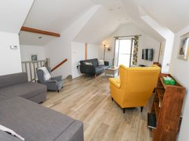 A living room with sofa and armchair at Coastguard Lookout in Wyke Regis