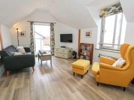 A living room with a sofa and armchair at Coastguard Lookout in Wyke Regis