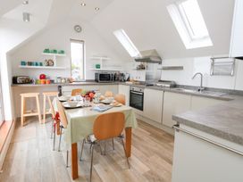 A kitchen with a table and chairs at Coastguard Lookout in Wyke Regis
