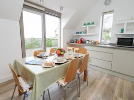 A kitchen with table and chairs at Coastguard Lookout in Wyke Regis