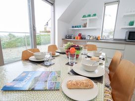 A dining room with a table set for breakfast at Coastguard Lookout in Wyke Regis