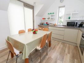 A kitchen with a dining table and chairs at Coastguard Lookout in Wyke Regis