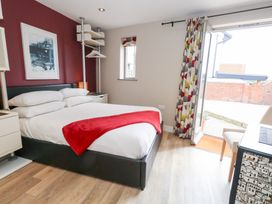 A bedroom with a bed and a window at Coastguard Lookout in Wyke Regis