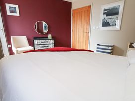 A bedroom with a bed and a chair at Coastguard Lookout in Wyke Regis