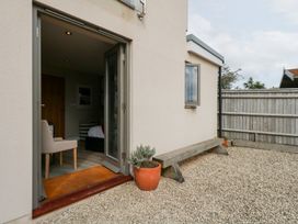 An outdoor area with a bench and potted plant at Coastguard Lookout in Wyke Regis