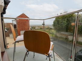 A balcony with two chairs and a view at Coastguard Lookout in Wyke Regis