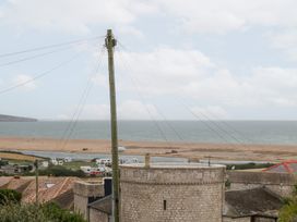 A view of the beach and sea with power lines at Coastguard Lookout in Wyke Regis