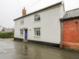 A house exterior view with a blue door at White Gates in Banham