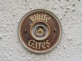 A nameplate fixed to a wall at White Gates in Banham