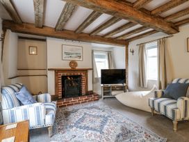 A living room with a fireplace and television at White Gates in Banham