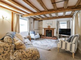 A living room with a sofa and fireplace at White Gates in Banham